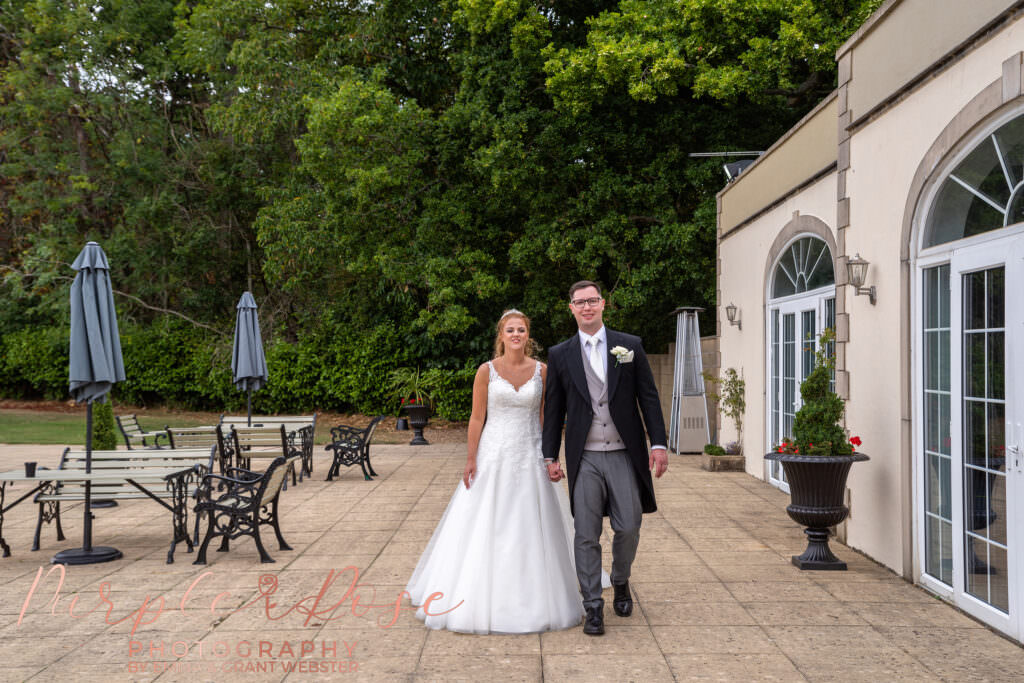 bride and groom walking hand in hand