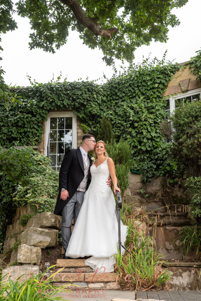 Bride and groom stood on stairway