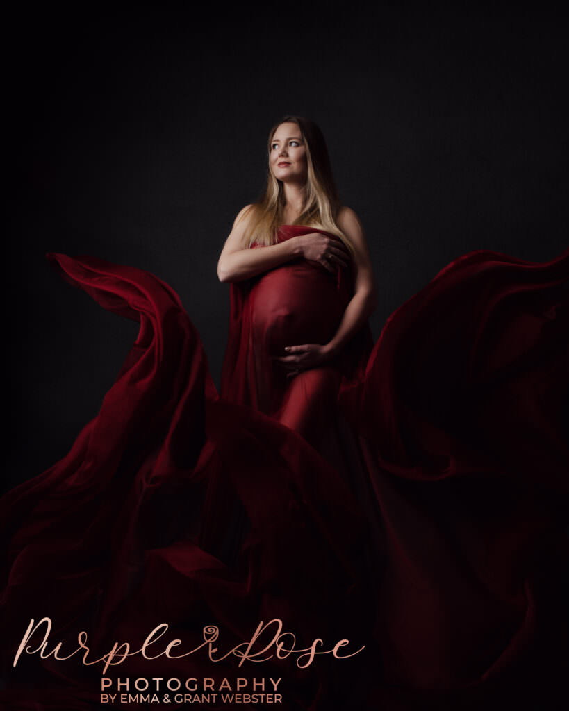 Mum to be draped in red fabric at her maternity photo shoot in Milton Keynes