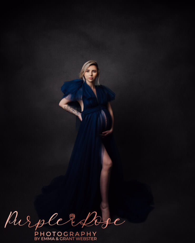 Expectant mother looking powerful in a navy blue dress at her maternity photoshoot in Milton Keynes