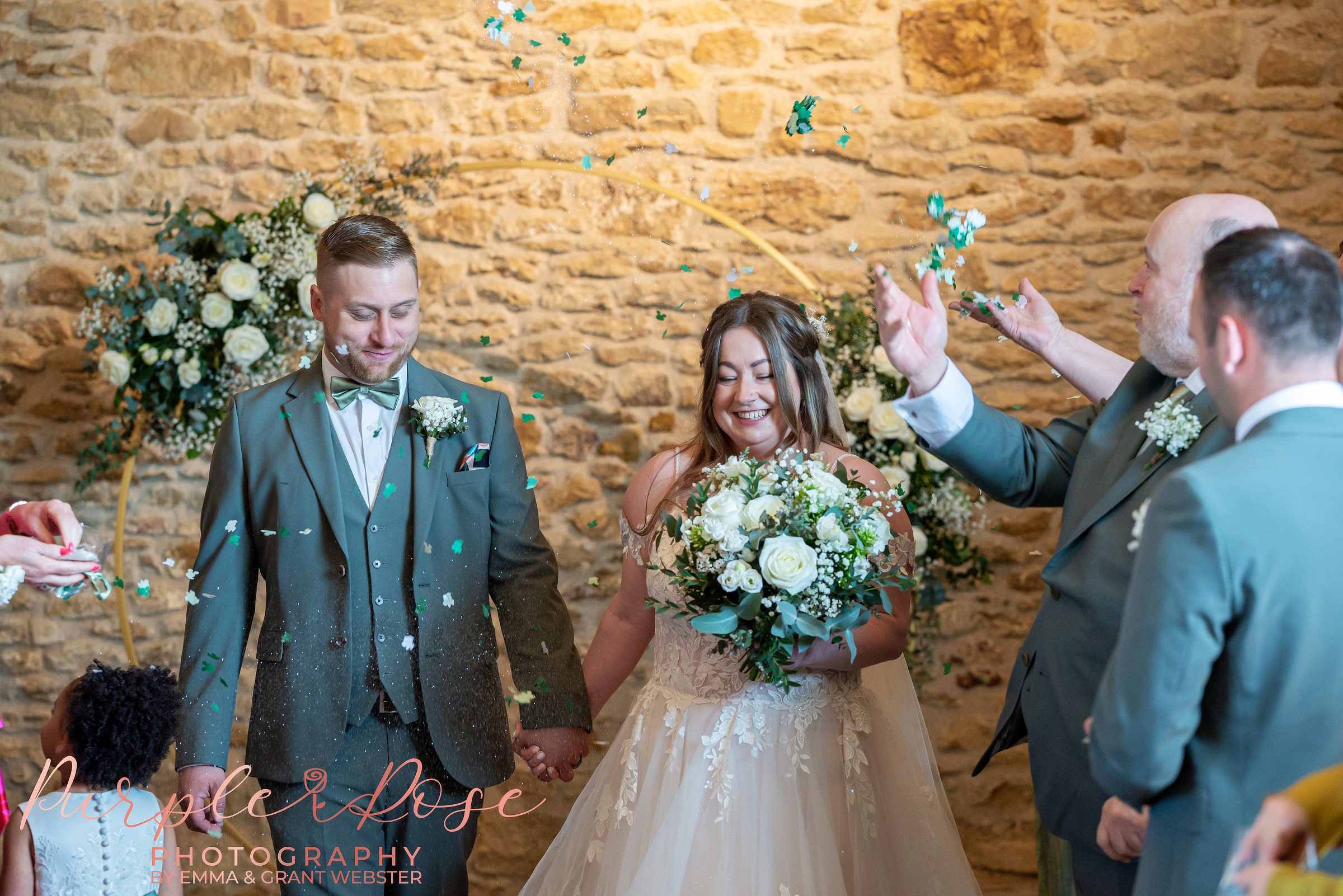 Dodford-Manor-Milton-Keynes-Wedding-Photographer_392 Bride and groom leaving their wedding ceremony as guest throw confetti at their wedding in Northampton