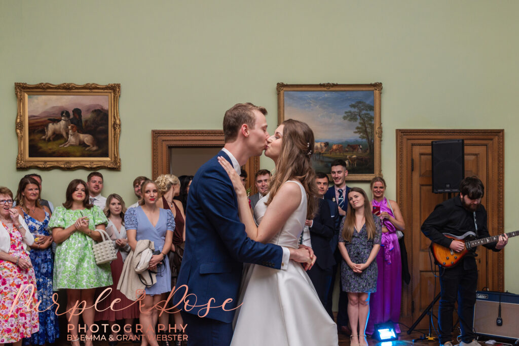 Photo of bride and groom kissing during the evening reception of their wedding in Milton Keynes