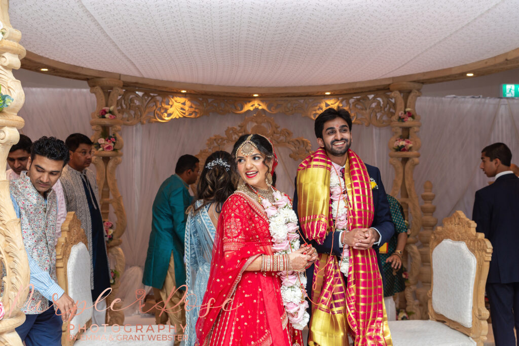 Photo of a Bride and groom laughing during their wedding ceremony in Milton Keynes
