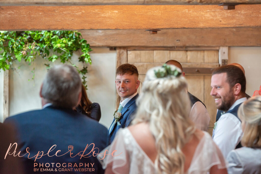 Photo of groom seeing his bride for the first time during the wedding ceremony in Northampton