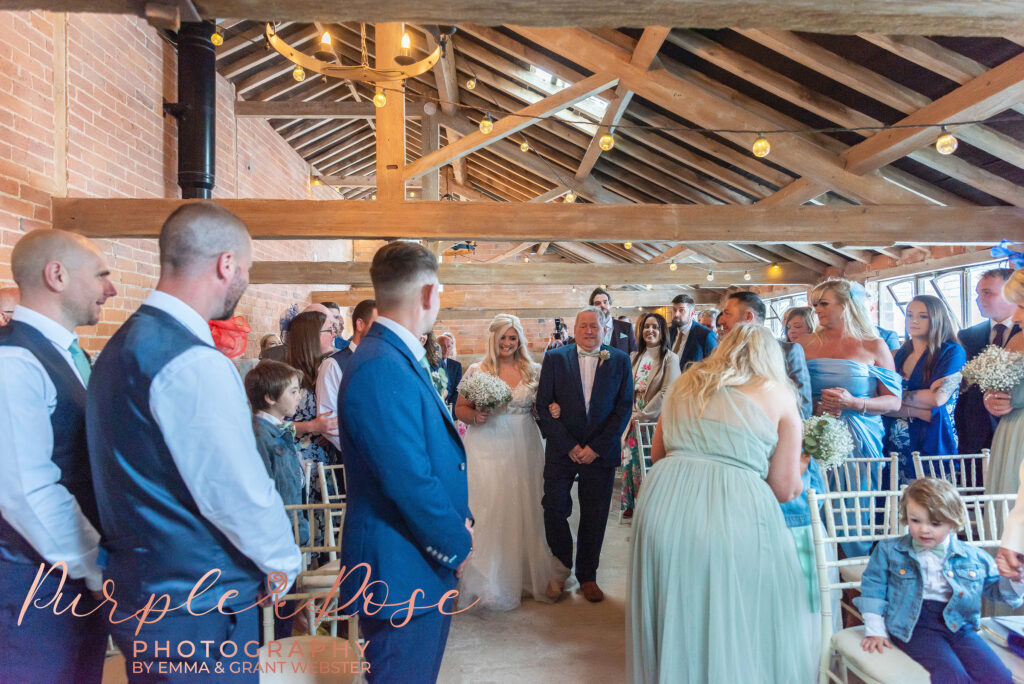 Photo of bride seeing her groom for the first time during their wedding ceremony in Northampton