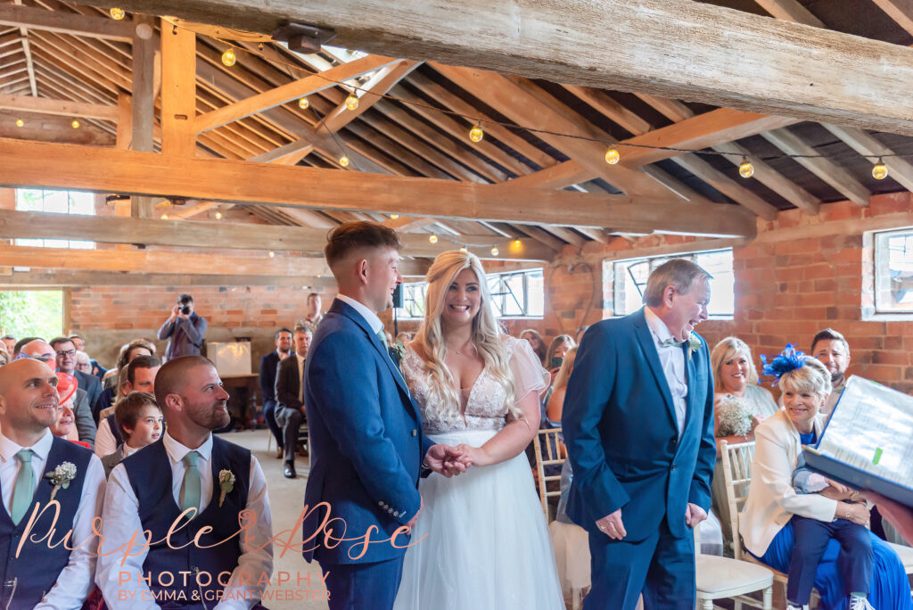 Bride and groom laughing during their wedding day in Northampton