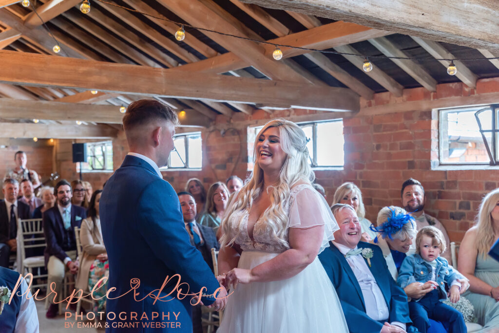 Photo of bride and groom laughing during their wedding day in Northampton