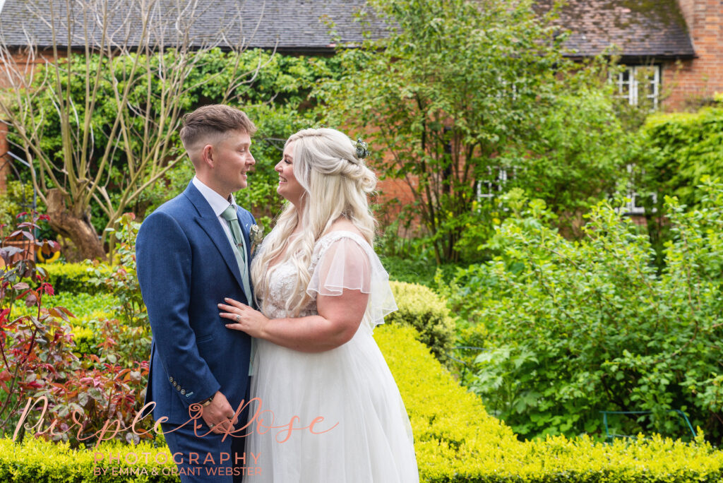 Phtoo of bride and groom stood in a garden on their wedding day in Northampton