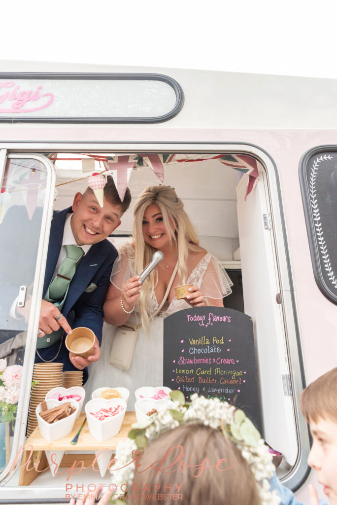 Photo of bride and groom in an ice cream van on their wedding day in Northampton