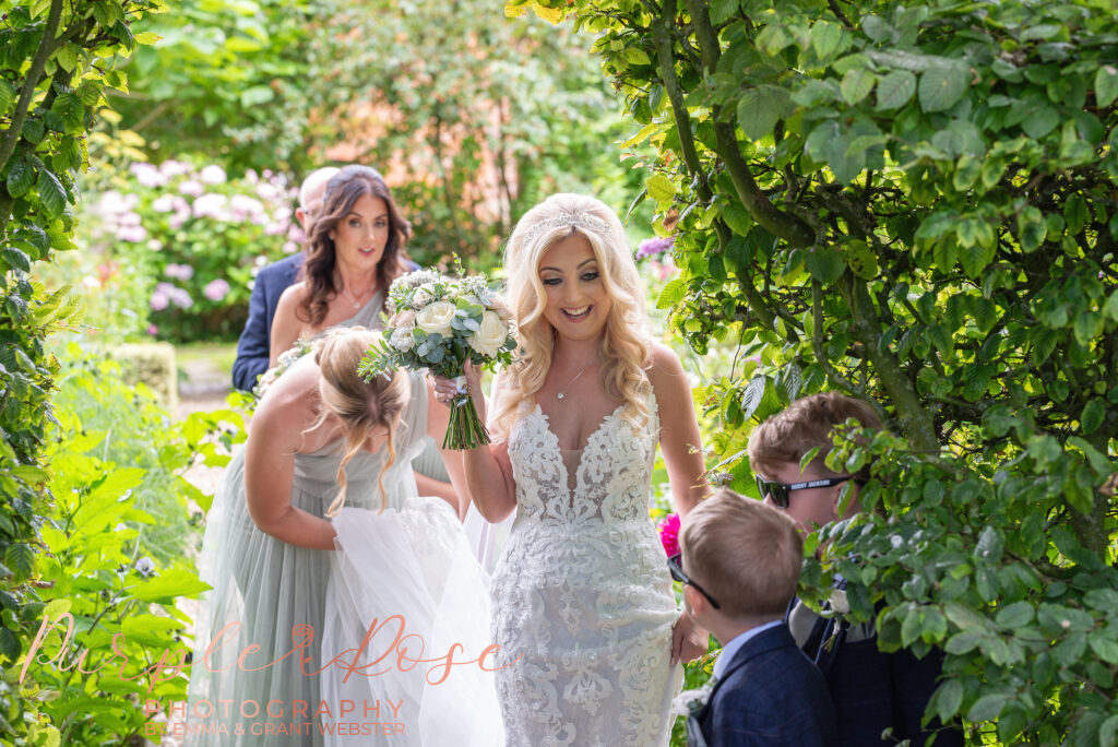 Photo of bride smiling at a page boy o her wedding day in Northampton