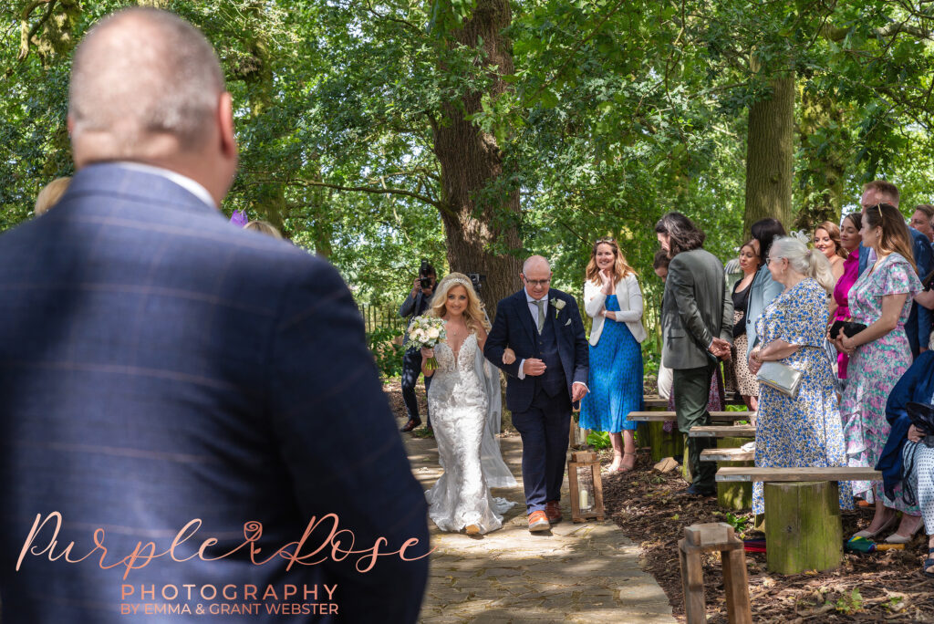 Photo of bride walking towards her groom to start the wedidng ceremony wedding day in Northampton