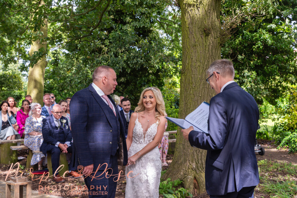 Photo of bride and groom smiling during their wedding ceremony wedding day in Northampton