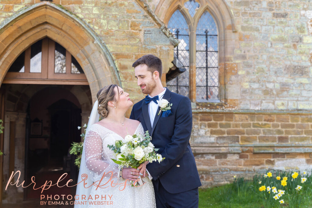 Photo of bride and groom outside their church after their wedding in Bedford