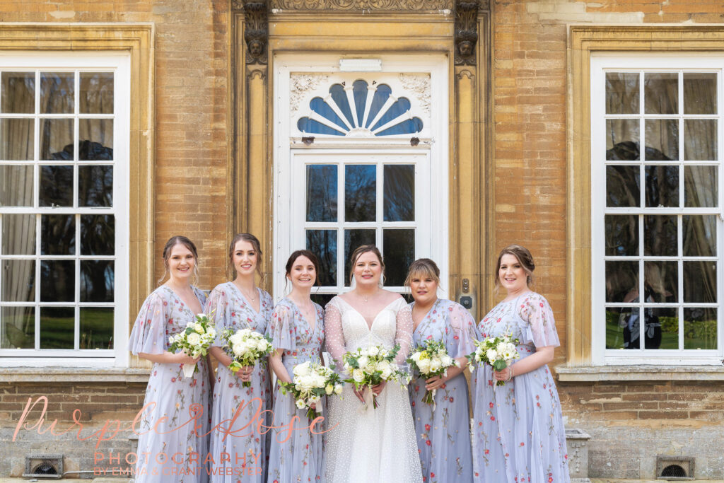 Photo of a bride with her bridesmaids outside her wedding venue in Milton Keynes
