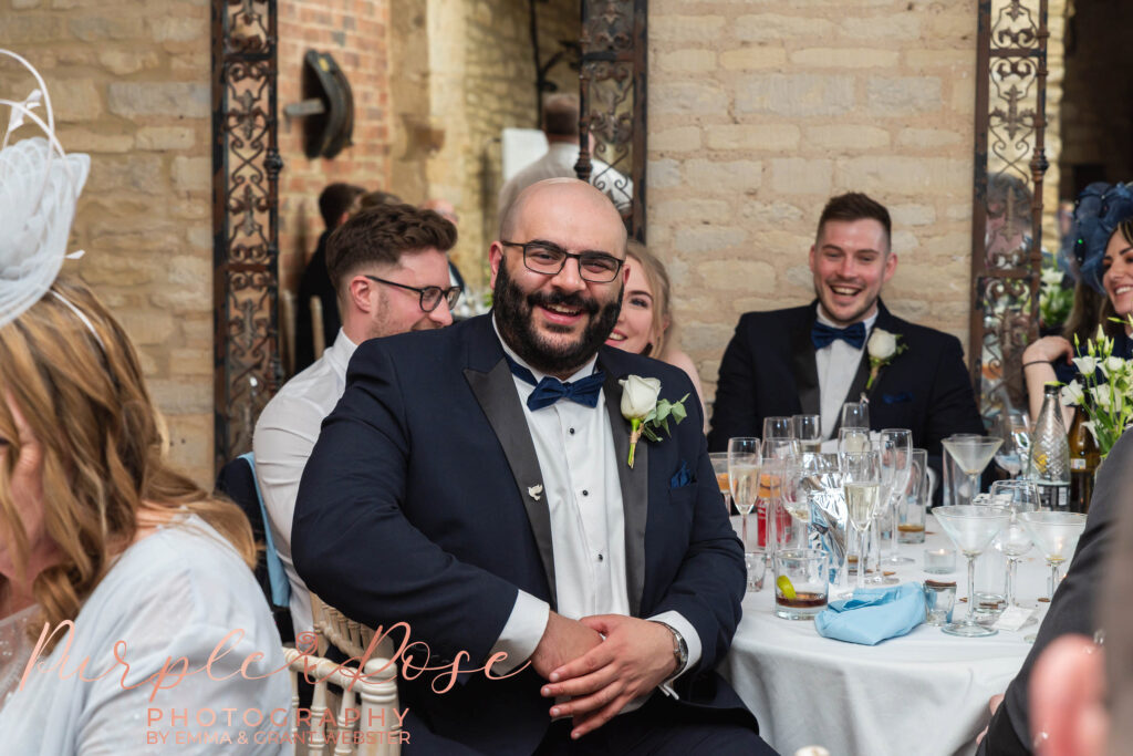 Photo of best man laughing during speaches at a wedding in Milton Keynes