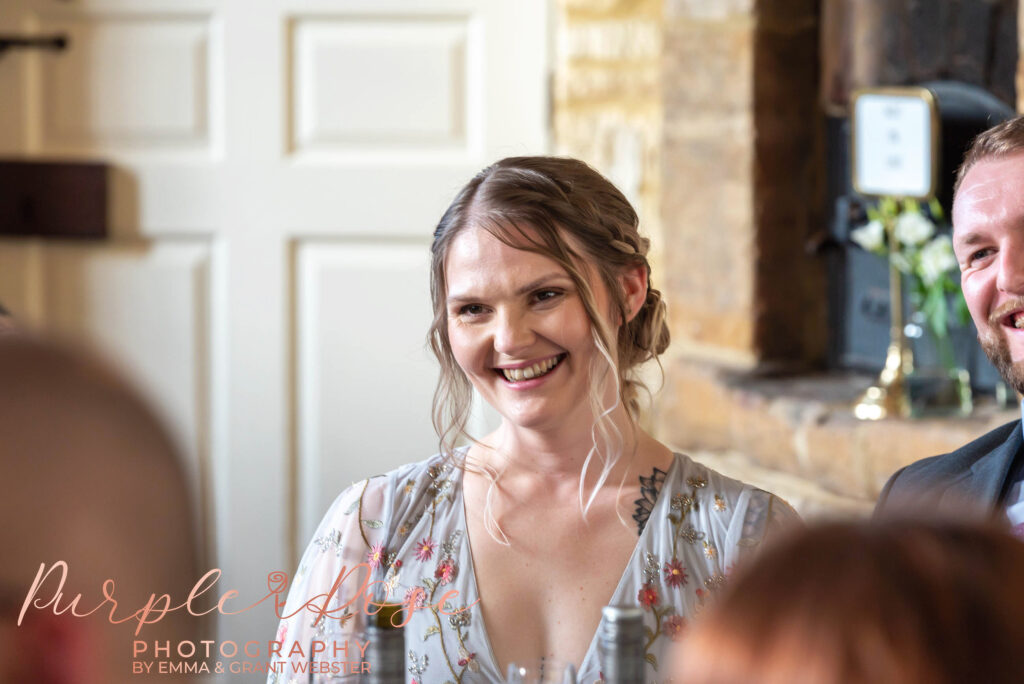 Phot of bridesmaid laughing during the speaches at a wedding in Milton Keynes