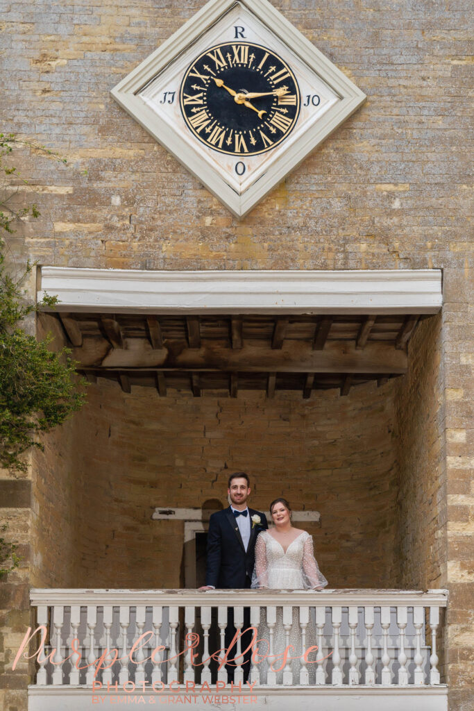 Photo of a bride and groom stood in a claock tower on their wedidng day in MIlton Keynes