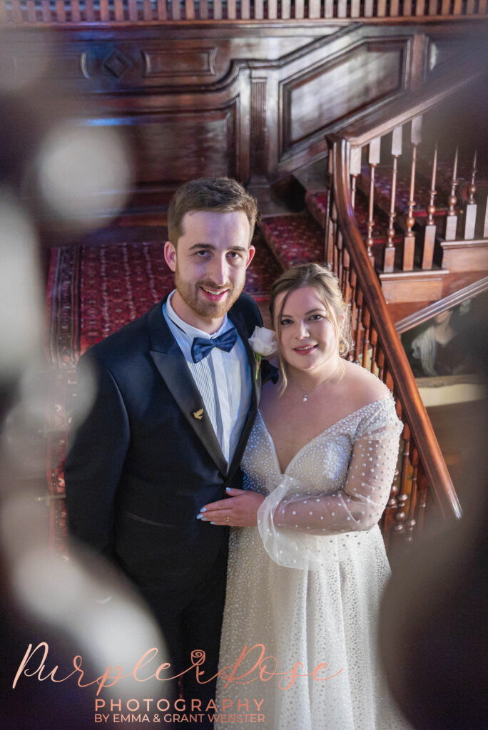 Photo of a bride and groom stood on a staircase on their wedding day in Milton Keynes