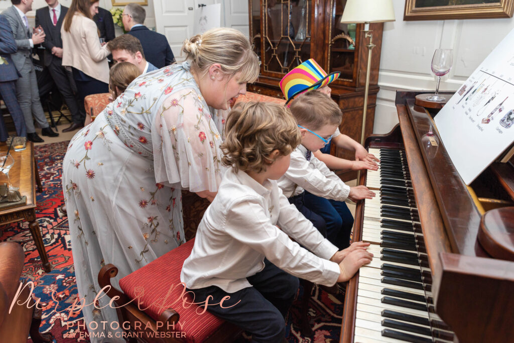 Photo of children playing a piano at a wedding in Milton Keynes