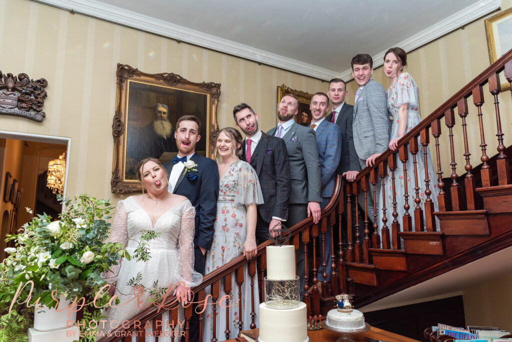 Photo of bride groom and their freinds on a staurcase at their wedding in MIlton Keynes