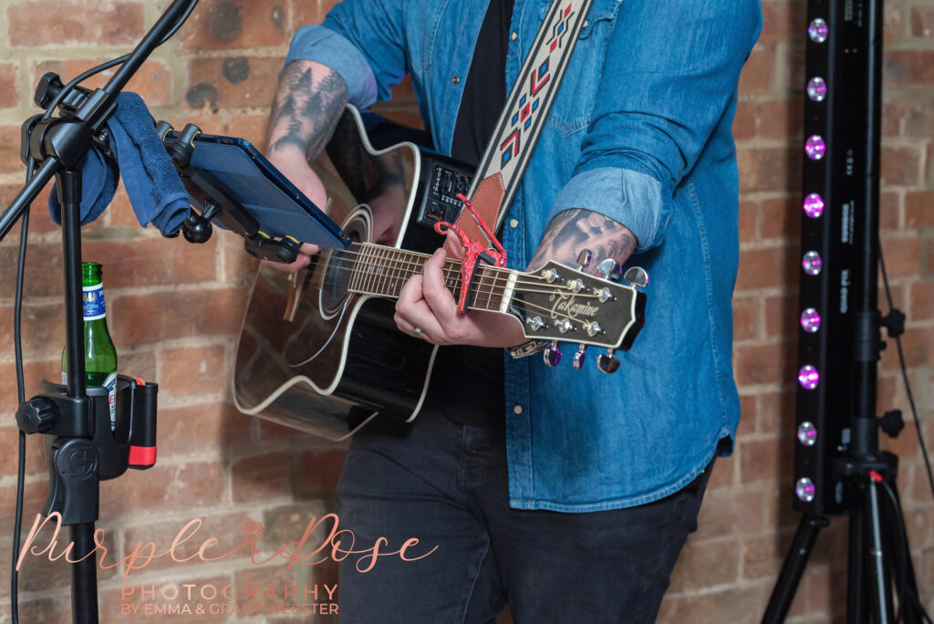 Photo of wedding band member playing their guitar at a wedding in Milton Keynes