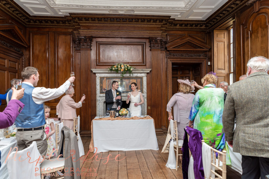 Photo of bride and groom during the wedding speaches on their wedding day in Milton Keynes